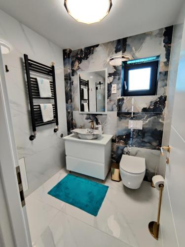 a bathroom with a sink and a toilet and a mirror at Kuća za odmor Villa Cesarica - Zagreb in Graberje Ivanićko