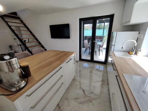 a kitchen with white cabinets and a counter top at Kuća za odmor Villa Cesarica - Zagreb in Graberje Ivanićko