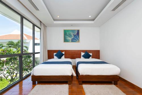 Ένα ή περισσότερα κρεβάτια σε δωμάτιο στο Ocean Sunny Villas Da Nang