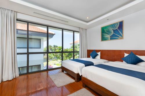 Ένα ή περισσότερα κρεβάτια σε δωμάτιο στο Ocean Sunny Villas Da Nang