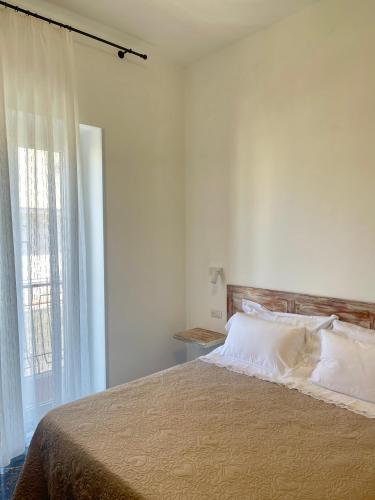 a bedroom with a large bed with a window at La Casa dei Nonni B&B in Vieste