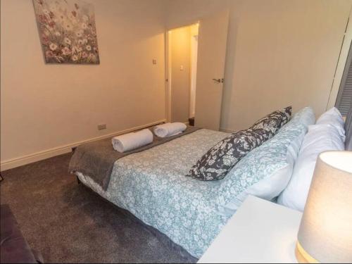 a bedroom with a bed with pillows on it at Beautiful Home near City Centre in Nottingham