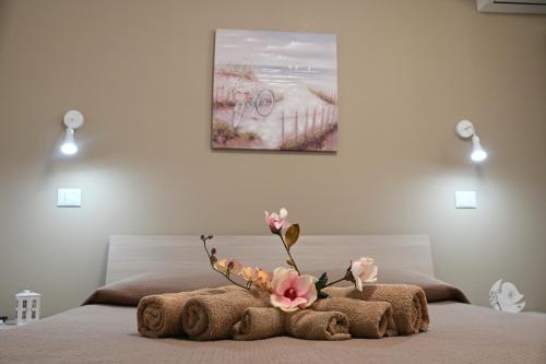 a bed with a stuffed animal with flowers on it at AL Quadrifoglio in Terrasini