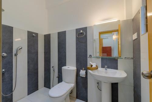 a bathroom with a toilet and a sink at Hotel Sobana Lake front in Udawalawe