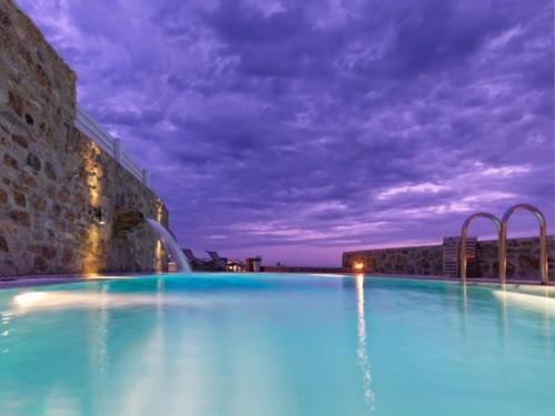 une grande piscine avec un toboggan aquatique dans l'établissement Villa Mare, Mykonos, à Kalafatis