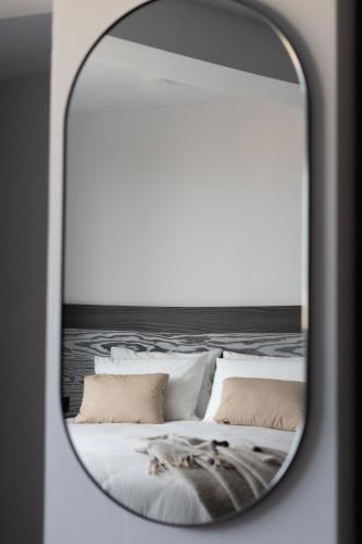 a mirror reflection of a bed with pillows at Park Heights by the Warren Collection in Msida