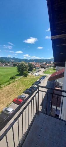 a balcony with a bunch of cars parked in a parking lot at Stan na dan -Bratunac- in Bratunac