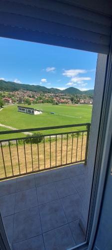 a view of a field from a window of a house at Stan na dan -Bratunac- in Bratunac