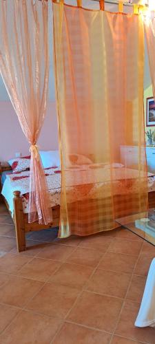 a bedroom with a bed and a window with curtains at Apartments Villa Bella Vista Hvar in Hvar