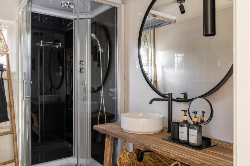 a bathroom with a sink and a mirror at Chalet Boisée in Voorthuizen