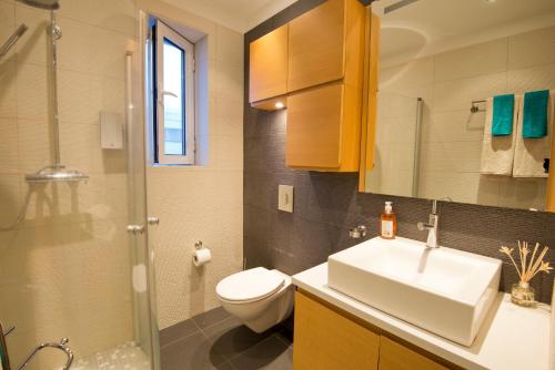a bathroom with a sink and a toilet and a shower at City Comfort Apartments in Reykjavík