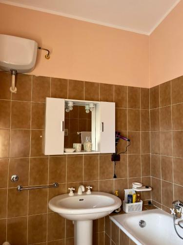 a bathroom with a sink and a mirror and a tub at ROOM365 in Lanciano
