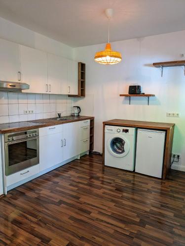 a kitchen with a washing machine and a washer at interaktiv Appartements in Ratingen - Düsseldorferstrasse in Ratingen