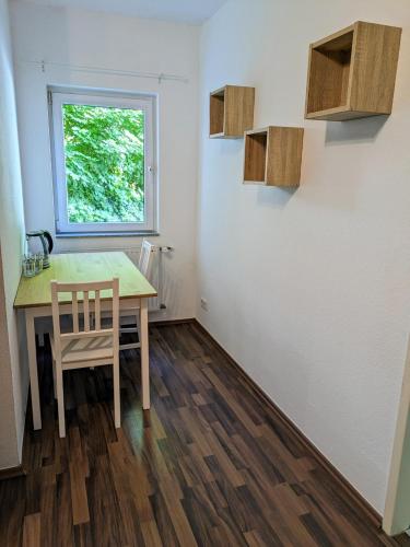 a dining room with a table and a window at interaktiv Appartements in Ratingen - Düsseldorferstrasse in Ratingen