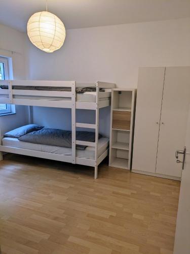 a room with two bunk beds and a lamp at interaktiv Appartements in Ratingen - Düsseldorferstrasse in Ratingen