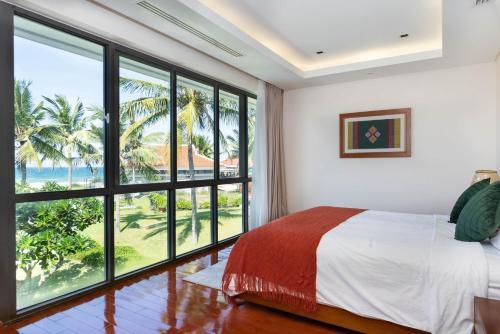 Ένα ή περισσότερα κρεβάτια σε δωμάτιο στο Ocean Sunny Villas Da Nang