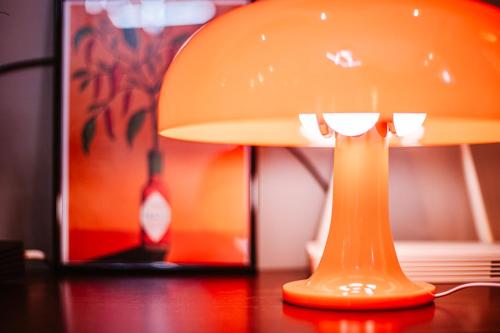an orange lamp sitting on top of a table at Lost At Sea in Sarandë