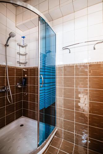 a shower with a glass door in a bathroom at Lost At Sea in Sarandë