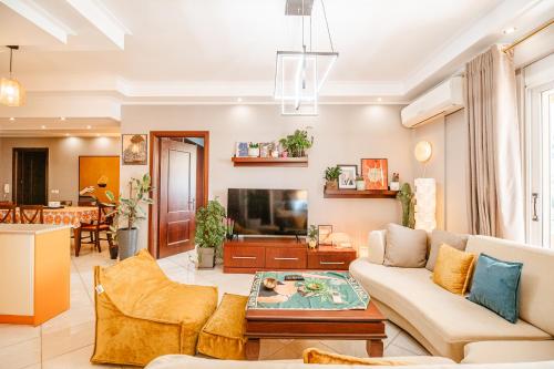 a living room with a couch and a tv at Lost At Sea in Sarandë