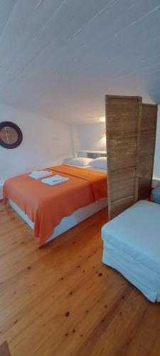 two beds in a room with wooden floors at Pefkohori Pegasus MoodSolutions Living in Pefkohori