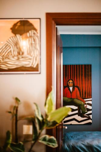 a man sitting in a chair in a room at Lost At Sea in Sarandë