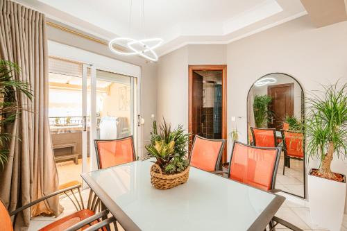 a dining room with a white table and chairs at Lost At Sea in Sarandë