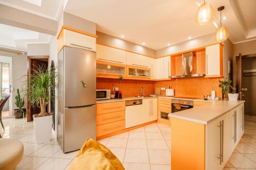 a large kitchen with a stainless steel refrigerator at Lost At Sea in Sarandë
