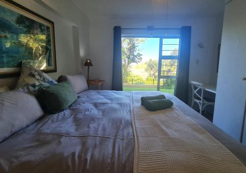 a bedroom with a large bed with a large window at Ramsgate Palms 3 in Ramsgate
