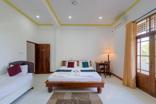 a bedroom with a bed with a sink in it at Hotel Sobana Lake front in Udawalawe