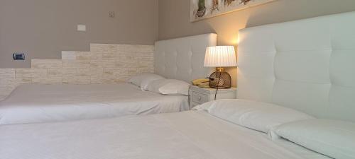 Ein Bett oder Betten in einem Zimmer der Unterkunft Hotel Palladium