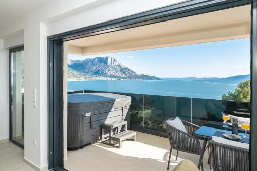 a house with a balcony with a view of the ocean at Villa Laganini Apartment 2&4 in Podaca