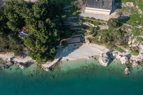 an aerial view of a beach with trees and water at Villa Laganini Apartment 2&4 in Podaca