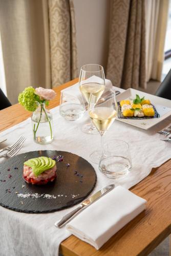 a table with plates of food and glasses of wine at Hotel Ristorante Magia del Brenta in Fiesso dʼArtico