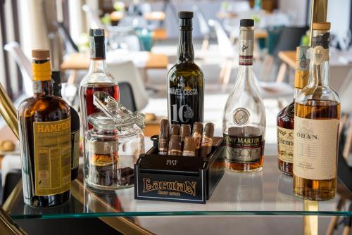 a glass table with bottles of alcohol on it at Hotel Ristorante Magia del Brenta in Fiesso dʼArtico