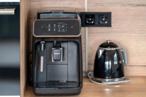 a black coffee maker sitting on top of a counter at Villa Laganini Apartment 2&4 in Podaca