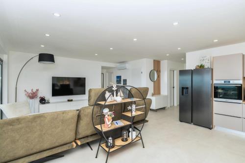 a living room with a couch and a refrigerator at Villa Laganini Apartment 2&4 in Podaca