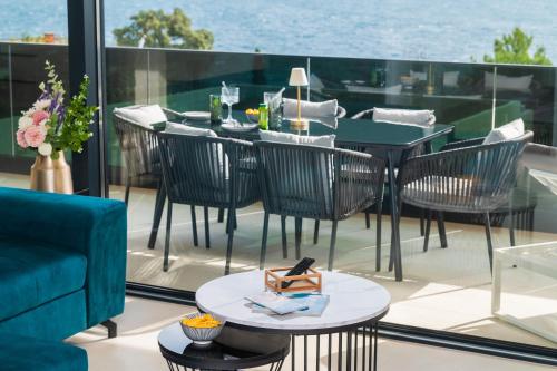 a patio with a table and chairs on a balcony at Villa Laganini Apartment 2&4 in Podaca