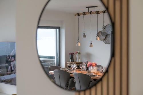 a dining room with a table and chairs in a mirror at Villa Laganini Apartment 2&4 in Podaca