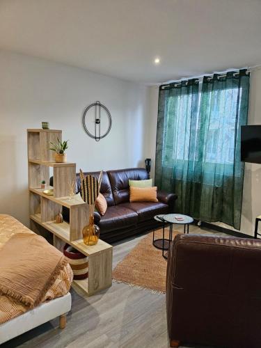 a living room with a couch and a table at Nassau2 F1 in Beauvais