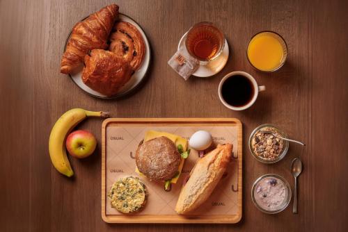 a table with a tray of breakfast foods and coffee at The Usual Rotterdam in Rotterdam