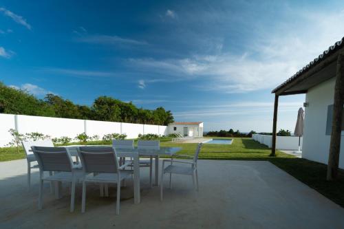 a dining table and chairs on a patio at Casa da Bela Vista (Piscina e Vista Mar) in Ponta Delgada