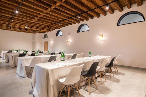 a group of tables and chairs in a room at Hotel Ristorante Magia del Brenta in Fiesso dʼArtico