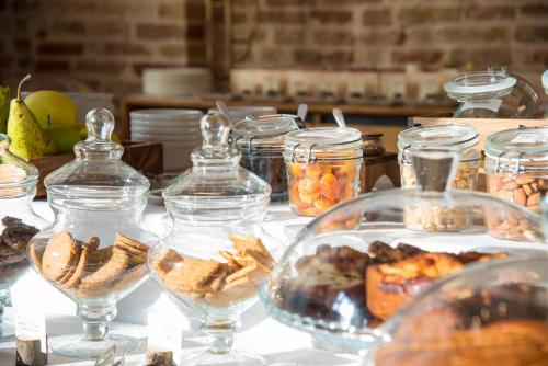 a table with glass jars of food and snacks at Hotel Ristorante Magia del Brenta in Fiesso dʼArtico