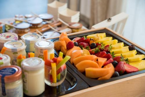a tray of fruit and vegetables on a table at Hotel Ristorante Magia del Brenta in Fiesso dʼArtico