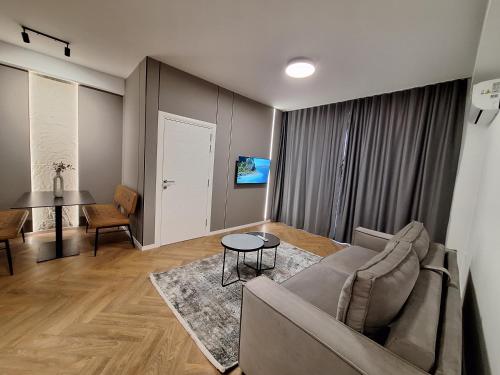a living room with a couch and a table at Modern Living Apartments in Skopje