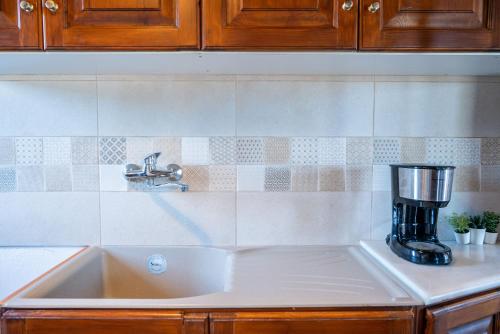 a kitchen sink with a coffee maker on it at Black Sand in Moutsouna Naxos