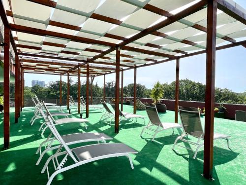 a row of lawn chairs under a pergola at BSA Gradina Hotel & Aquapark - All Inclusive in Golden Sands