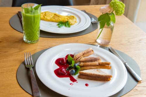 a table with two plates of food and a drink at Hotel Ristorante Magia del Brenta in Fiesso dʼArtico