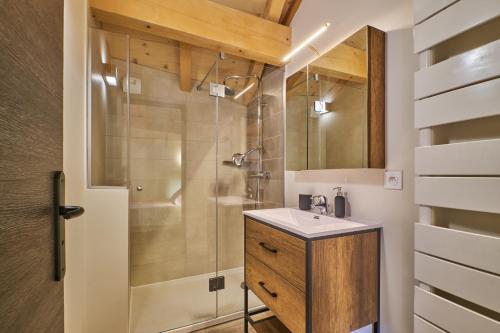 a bathroom with a shower and a sink at La Grange in LʼHuez