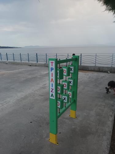 a sign on the side of a road next to the ocean at Seaview studio in Neapolis